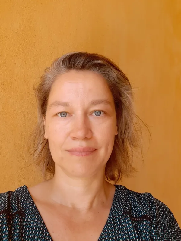 Nataša Pantić standing against an orange wall.