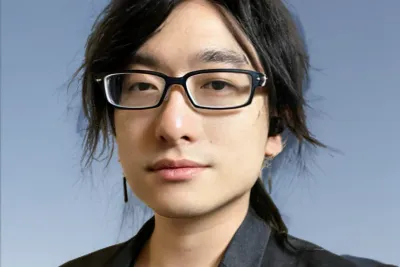Acer Chang wearing a black blazer and glasses.